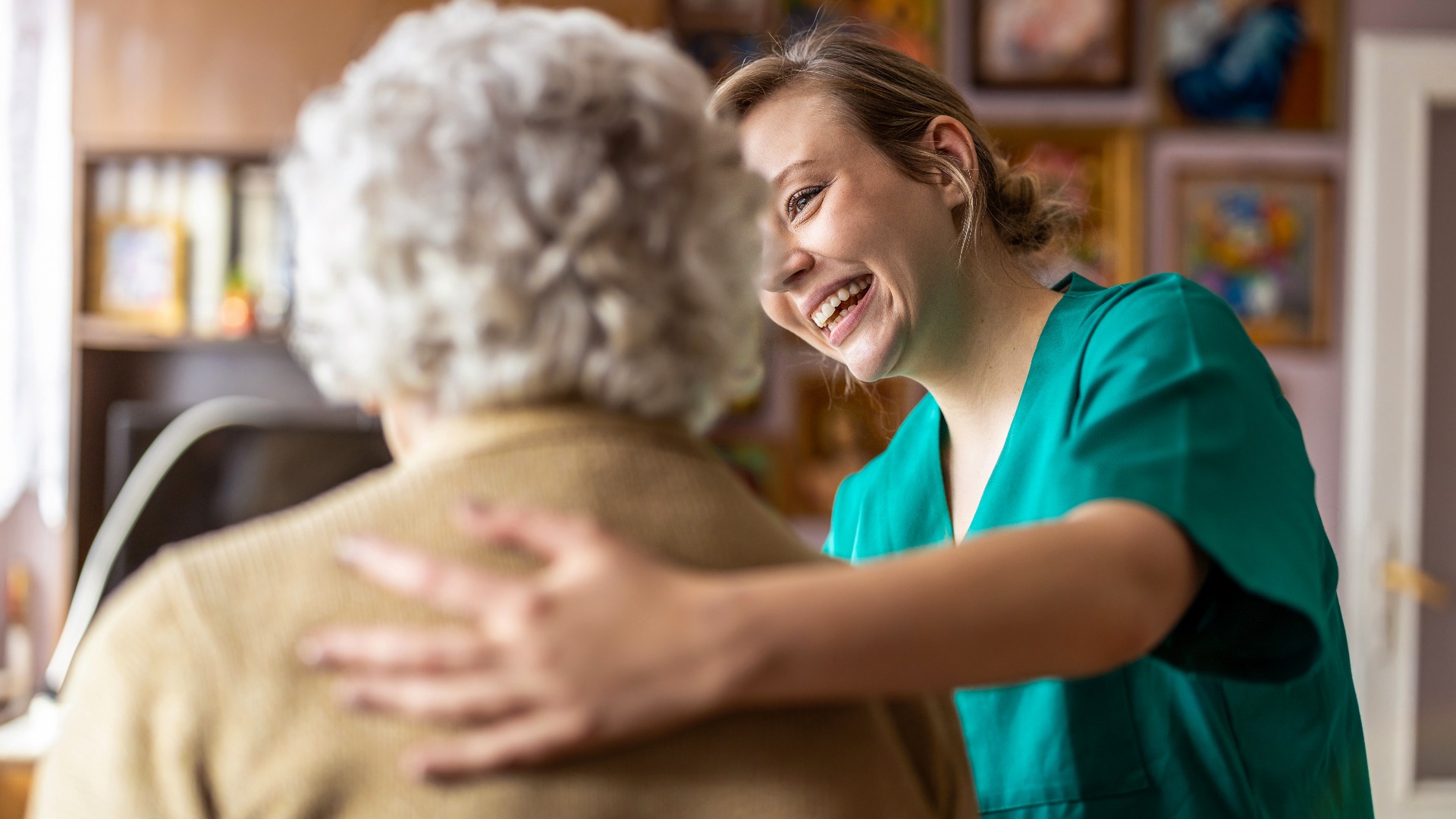 Friendly nurse supporting an elderly lady